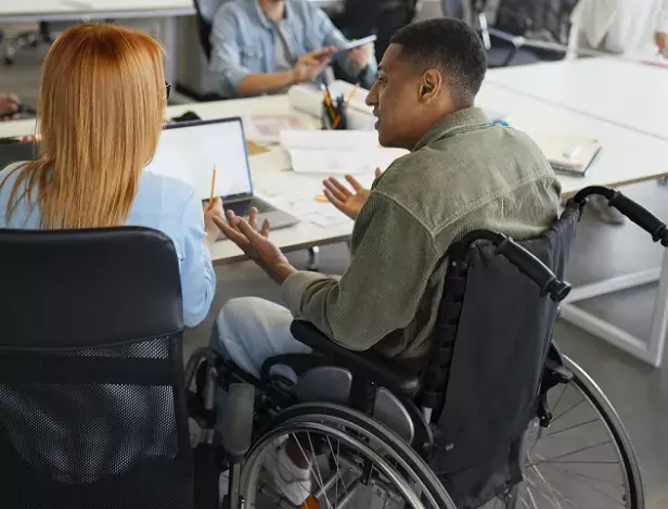 disabled-man-wheelchair-working-his-office-job